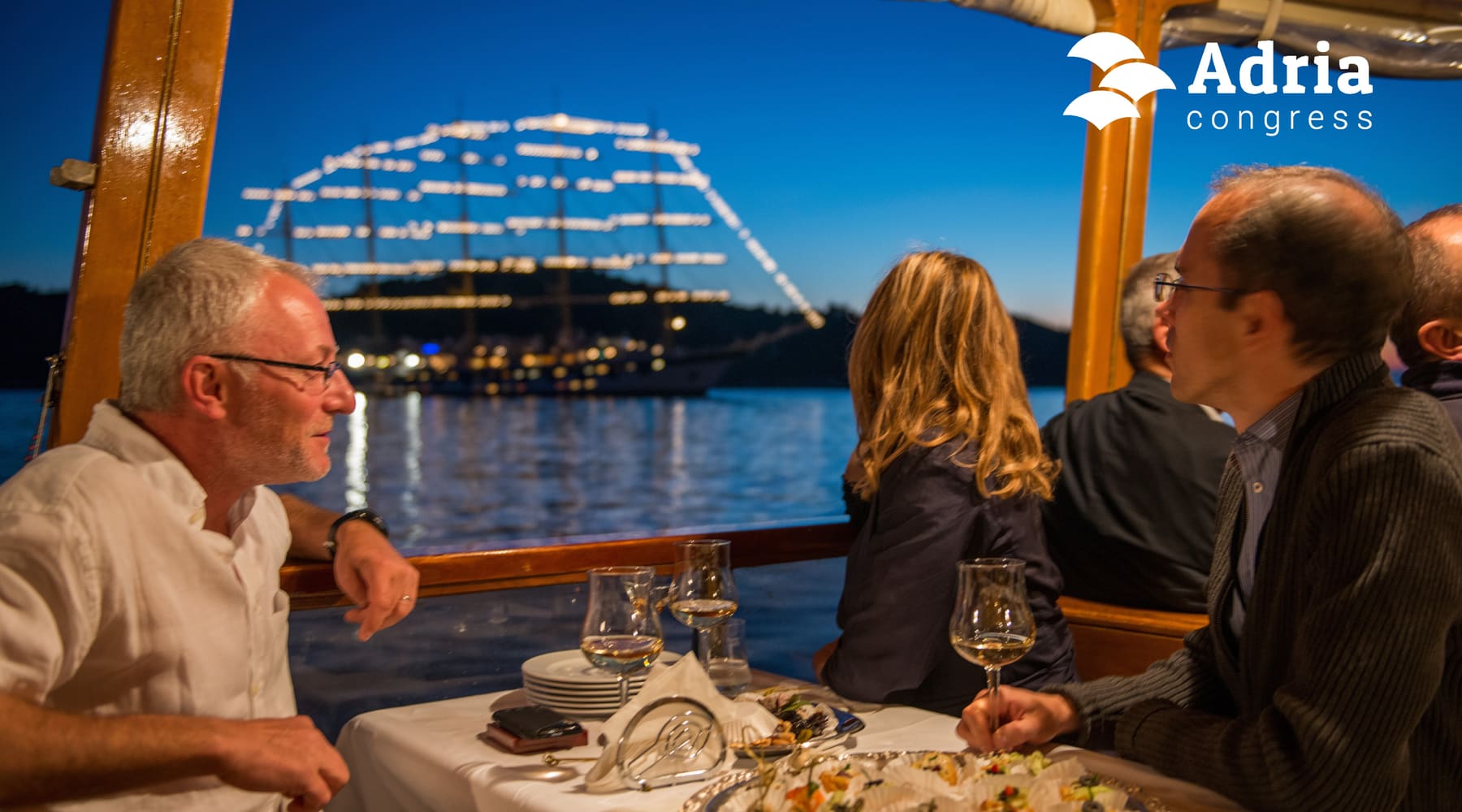 Guests at dinner on a boat in the evening, organised by Adria Congress
