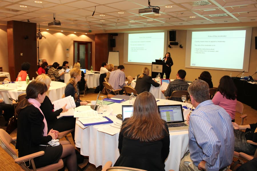A working session with round tables and presentation screens